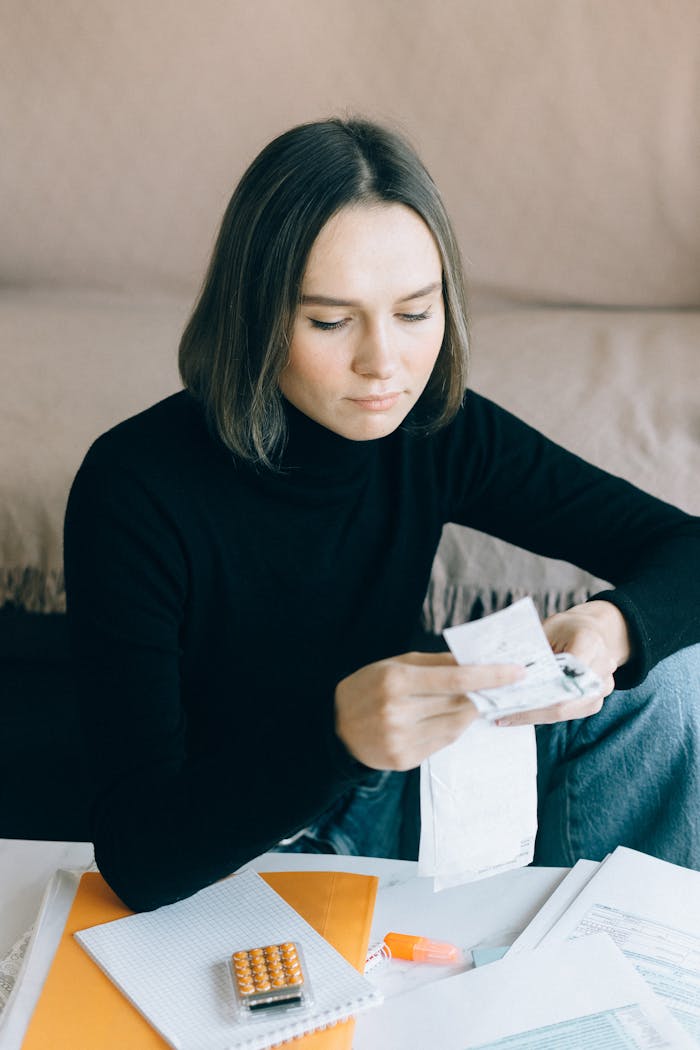 Young woman reviewing bills